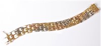 Lot 2189 - An 18ct tri-coloured gold bracelet, the...