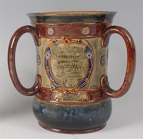 Lot 2092 - A Doulton stoneware commemorative tyg, of...