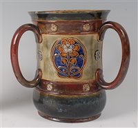 Lot 2092 - A Doulton stoneware commemorative tyg, of...