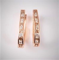 Lot 2196 - A pair of '14k' diamond earrings, the oval...