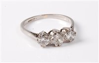 Lot 2257 - A platinum three stone diamond ring, the three...