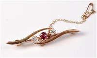 Lot 2272 - A 15ct three stone ruby and diamond brooch,...
