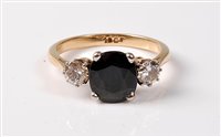 Lot 2244 - A three stone sapphire and diamond ring, the...