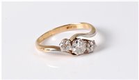 Lot 2548 - An 18ct three stone diamond ring, the three...