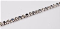 Lot 2536 - An '18k' white gold sapphire and diamond...