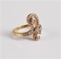 Lot 1168 - An 18ct diamond 'upfinger' ring, the principal...