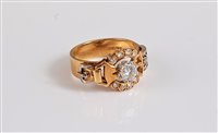 Lot 1201 - An 18ct diamond buckle ring, the principal...