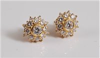 Lot 1174 - A pair of diamond cluster earrings, the...