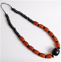 Lot 2571 - A faux butterscotch amber and black bead...