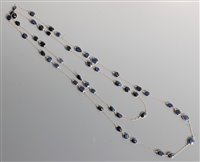 Lot 2669 - A long sapphire necklace, the mixed cut...