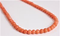 Lot 2585 - A coral bead necklace, the round coral beads,...