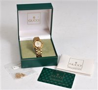 Lot 2554 - A lady's Gucci wristwatch, the signed round...