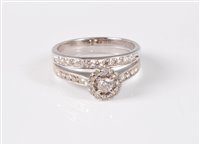 Lot 2518 - An 18ct white gold diamond halo ring and...