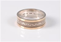 Lot 460 - An 18ct and silver ring, the central band of...