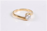 Lot 2578 - An 18ct diamond solitaire crossover ring, the...