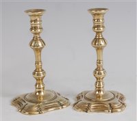 Lot 1257 - A pair of mid-18th century brass taper sticks,...