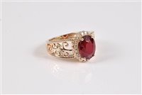 Lot 1187 - A 14k treated ruby and diamond ring, the oval...