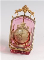Lot 1297 - A circa 1900 cranberry glass watch holder,...