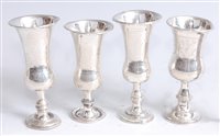 Lot 1108 - *A set of three Edwardian silver kiddush cups,...