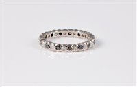 Lot 2575 - A black and white diamond eternity ring, the...