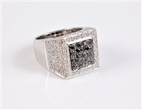 Lot 1202 - An 18ct black and white diamond ring, the...