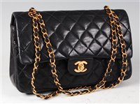 Lot 176 - A Coco Chanel black leather quilted flat-bag,...