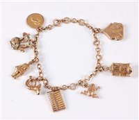Lot 446 - A 9ct charm bracelet, with seven variously...