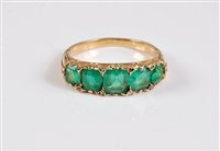 Lot 1179 - A five stone emerald ring, the five graduated...