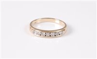Lot 405 - An 18ct diamond half hoop ring, the round...