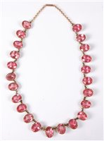 Lot 432 - An early-mid 20th century pink paste riviere...