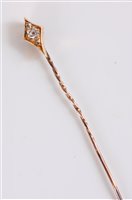 Lot 451 - A diamond set stick pin, the old mine cut...