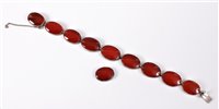 Lot 453 - A silver and carnelian bracelet, the oval...