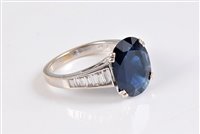 Lot 1159 - An 18ct sapphire and diamond ring, the oval...