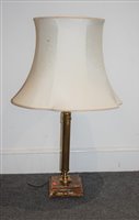 Lot 19 - A brass pedestal oil lamp having urn shaped...