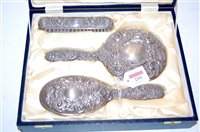 Lot 219 - A cased silver and embossed three-piece...