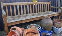 Lot 1173 - A contemporary stained and slatted teak...