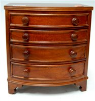 Lot 131 - A reproduction miniature hardwood bowfront...