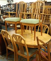 Lot 1333 - A contemporary teak dining suite comprising...