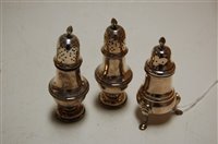 Lot 373 - A pair of George V silver pedestal pepperettes;...