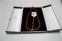 Lot 388 - A graduated beaded amber necklace on a 9ct...