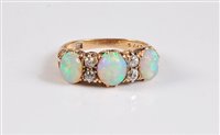 Lot 1170 - An 18ct three stone opal and diamond ring, the...