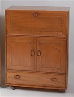 Lot 454 - An Ercol light elm Windsor 469 drinks cabinet,...