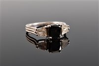 Lot 1205 - A platinum black and white diamond ring, the...