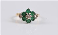 Lot 2703 - An 18ct emerald and diamond cluster ring, the...