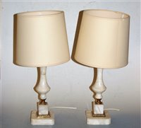 Lot 115 - A pair of onyx and brass mounted table lamps...