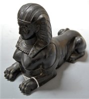 Lot 223 - An Egyptian Revival bronzed metal sphinx after...