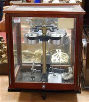 Lot 176 - A set of laboratory scales in glazed mahogany...