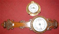 Lot 187 - A late Victorian carved oak cased aneroid...