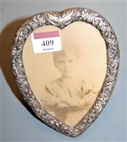 Lot 409 - A circa 1900 silver clad heart shaped easel...