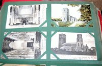 Lot 511 - An early 20th century postcard album and...